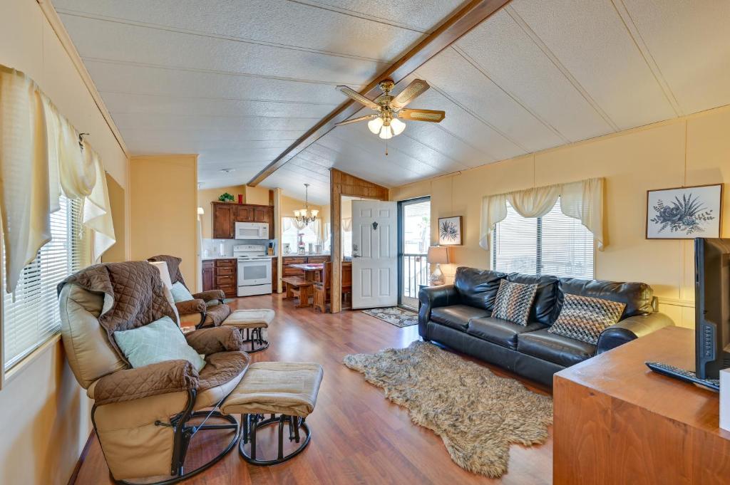 a living room with a couch and a ceiling fan at Yuma Vacation Rental with Resort Pool and Hot Tub! in Yuma