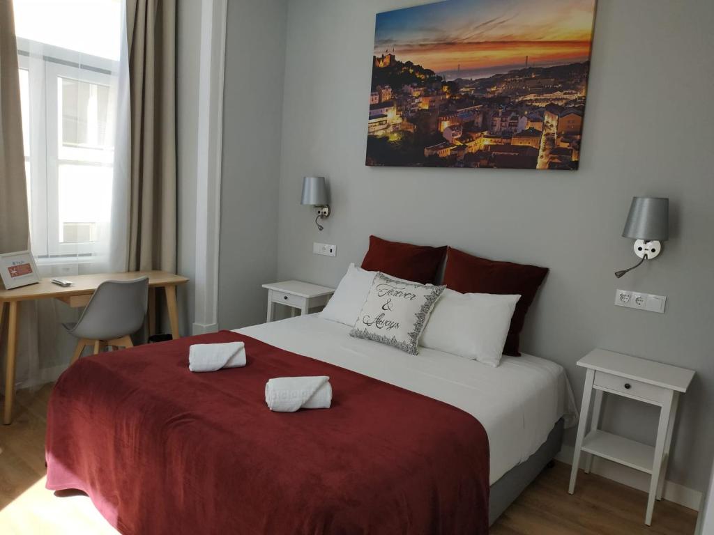a bedroom with a bed with a red blanket at Great Stay Fanqueiros Guest House 3 in Lisbon