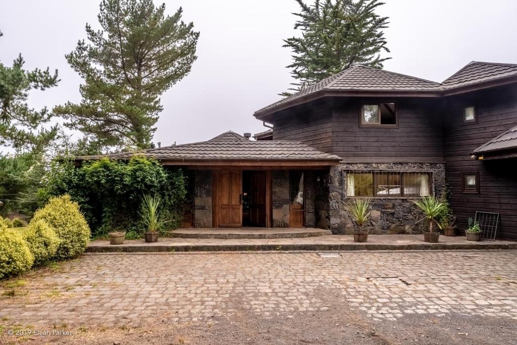 a house with a brick driveway in front of it at "Beautiful Lake House" in Pucón