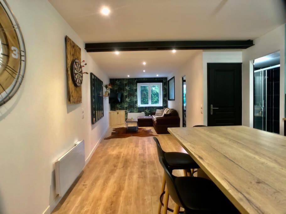 a living room with a large wooden table and chairs at Hello Bayeux #2 by Melrose in Bayeux