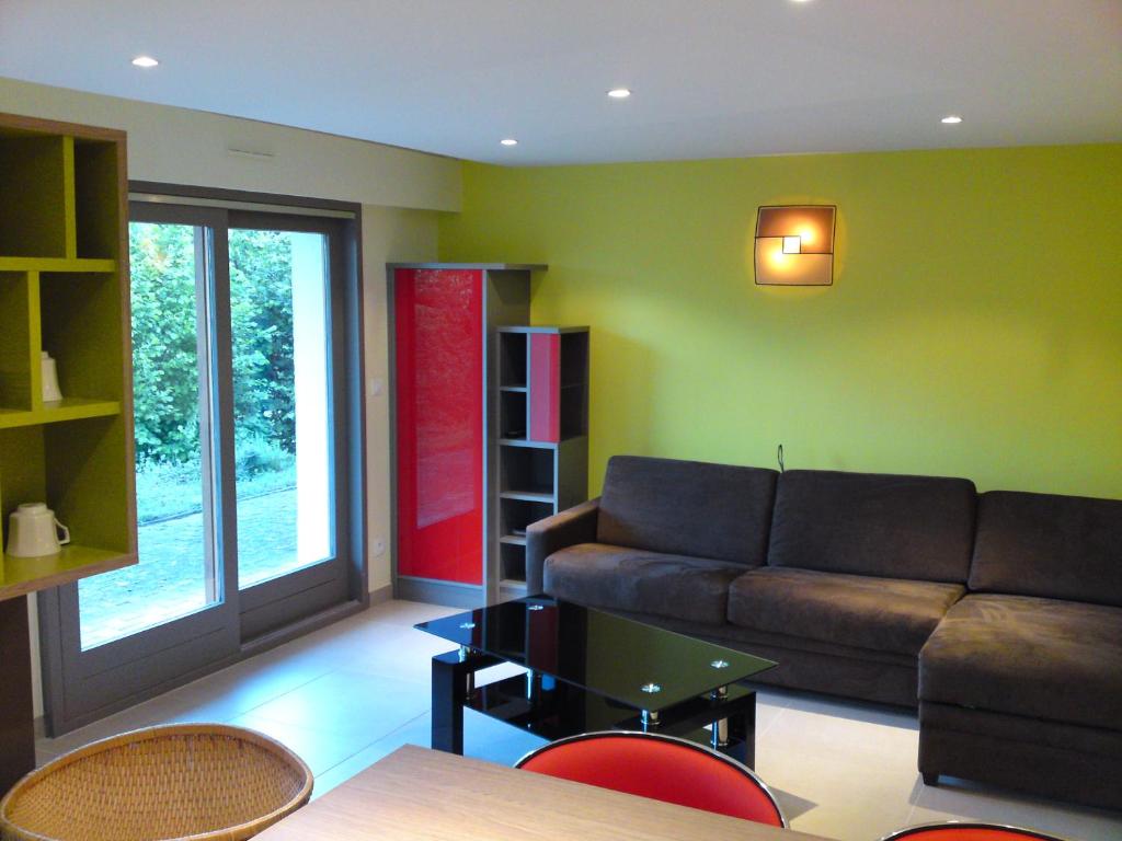 a living room with a couch and a table at Gîte des Pringets in Tresserves