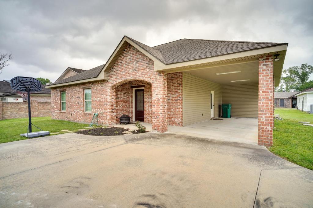 a brick house with a driveway at Lake Charles Vacation Rental - 3 Mi to Casinos! in Lake Charles