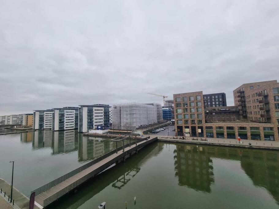 a body of water in a city with buildings at ExCeL London-Exclusive 3 Bedroom in North Woolwich