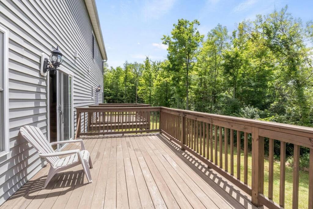 a wooden deck with a chair on a house at Escape to NY Finger Lakes Wine Country Just 20 Minutes From Ithaca in Lansing