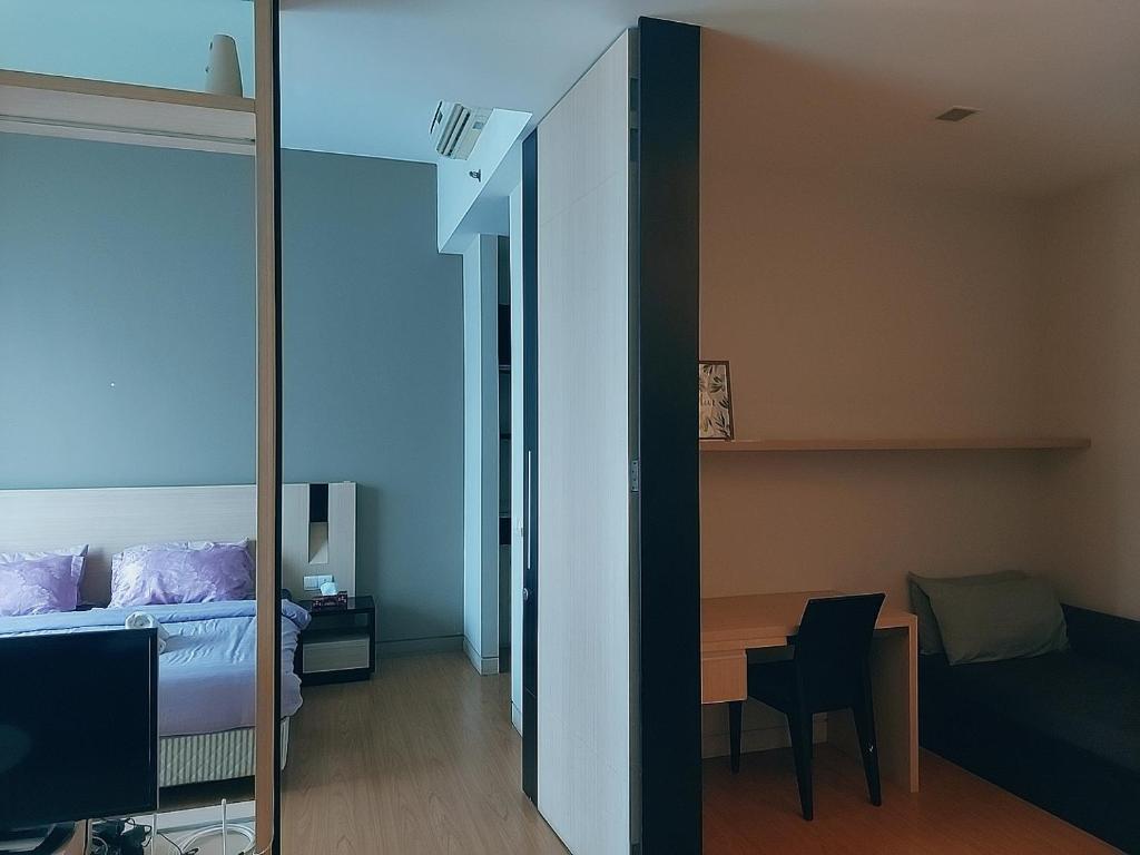 a bedroom with a bed and a table and a mirror at Swiss Garden Residence affordable stay in Kuala Lumpur