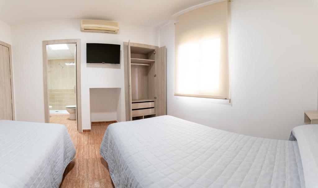 Postel nebo postele na pokoji v ubytování Hostal Viñuela