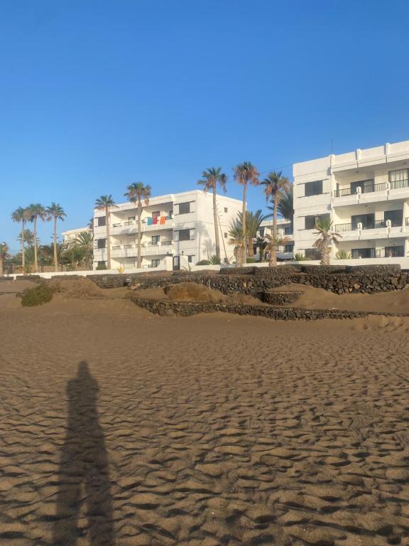 a shadow of a person standing on the beach at Strandapartment Costa Luz-Ozean View in Tías