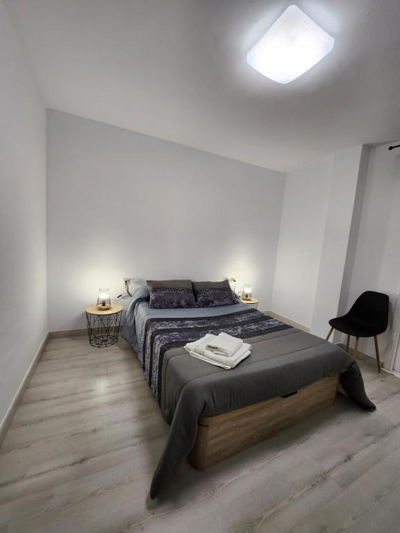 a bedroom with a large bed in a white room at Cuña Buenavista in Ourense