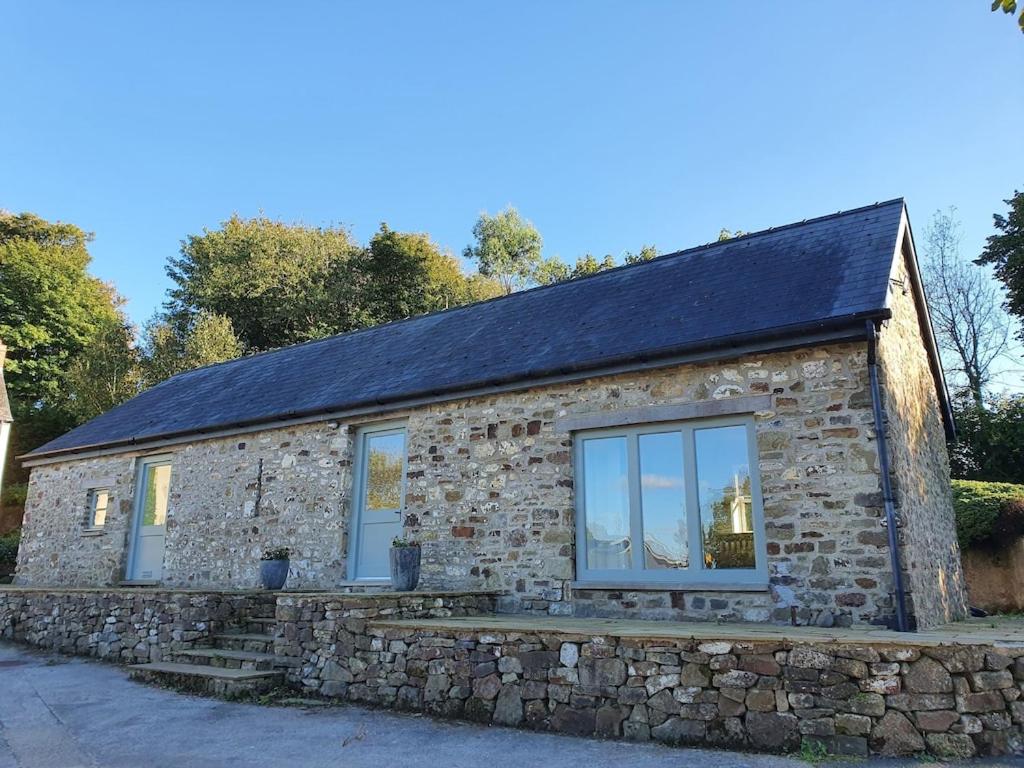 a stone house with a stone wall at Bandar Cottage, farm cottage, close to Narberth, Pembrokeshire in Narberth