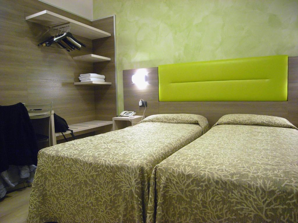 Postel nebo postele na pokoji v ubytování Hotel Siena