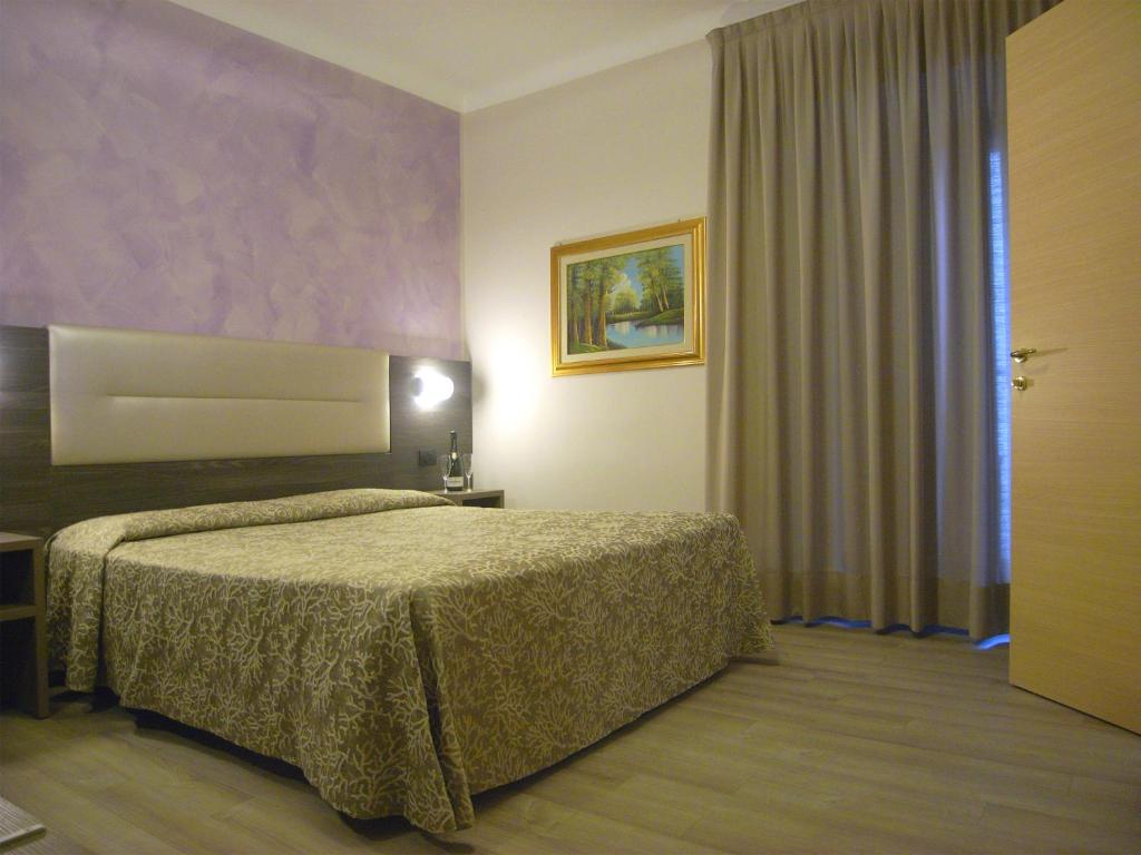 Postel nebo postele na pokoji v ubytování Hotel Siena