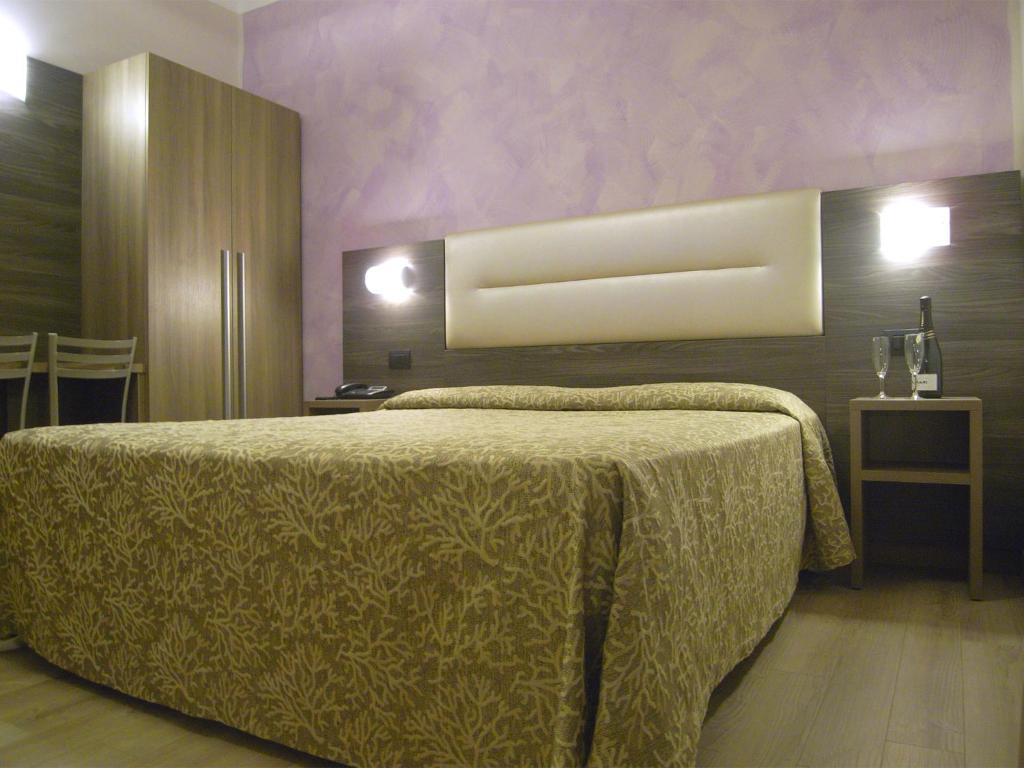 Postel nebo postele na pokoji v ubytování Hotel Siena