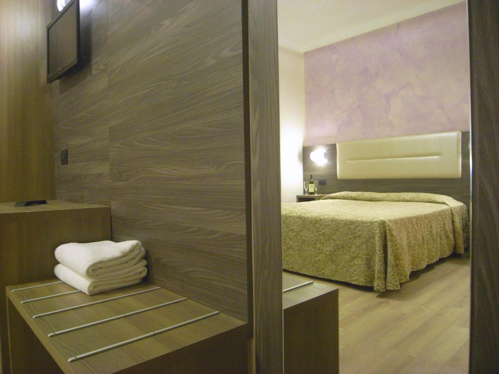 Postel nebo postele na pokoji v ubytování Hotel Siena