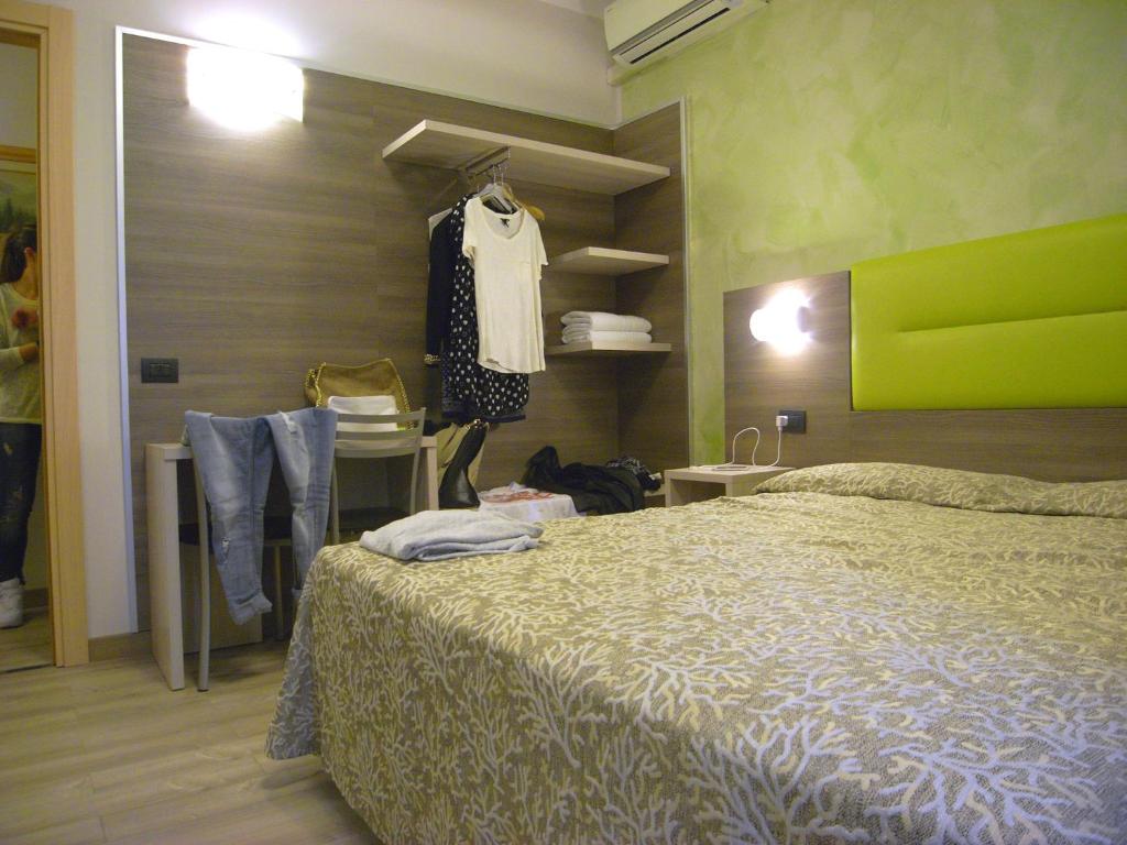 Postel nebo postele na pokoji v ubytování Hotel Siena