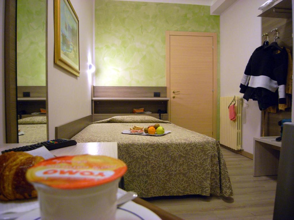 Postel nebo postele na pokoji v ubytování Hotel Siena