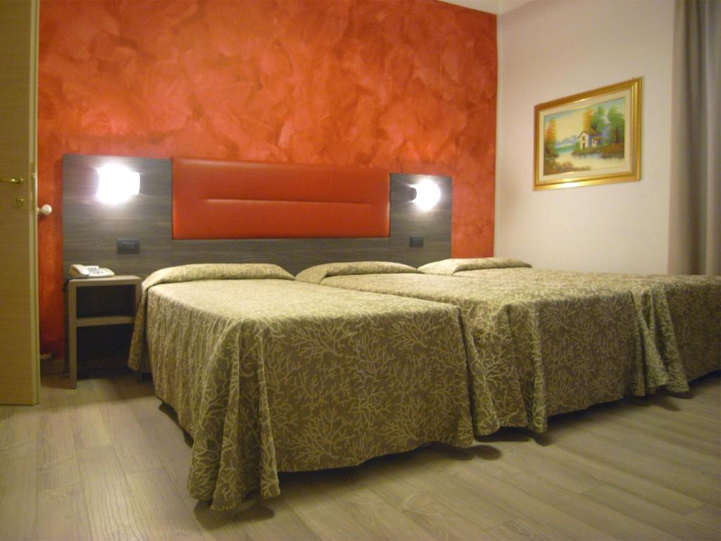 Postel nebo postele na pokoji v ubytování Hotel Siena