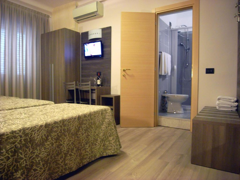 Postel nebo postele na pokoji v ubytování Hotel Siena