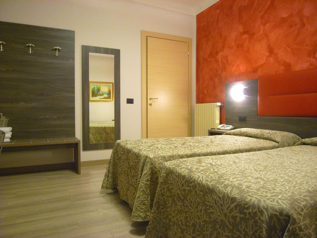 Postel nebo postele na pokoji v ubytování Hotel Siena
