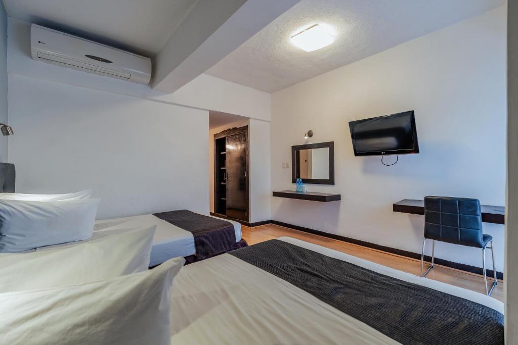 Postel nebo postele na pokoji v ubytování Hotel Maya Yucatan