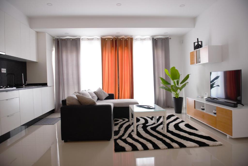 a living room with a couch and a zebra rug at Duarte Apartments - Morabeza in Mindelo