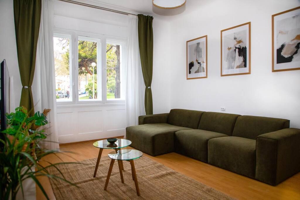 a living room with a couch and a table at BRAND NEW City Center Apartment Nostalgija in Split