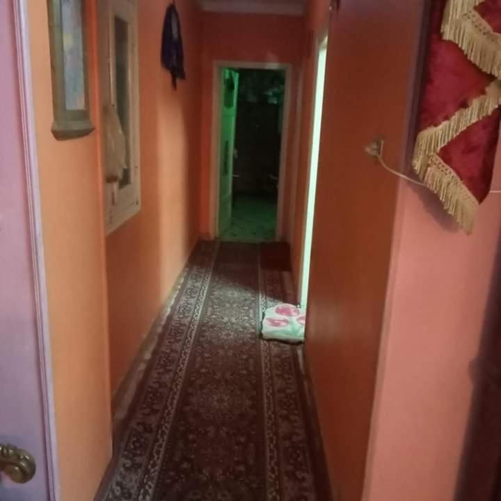 a hallway of a house with orange walls and a room with a hallway at منزل مصطفى العوام 