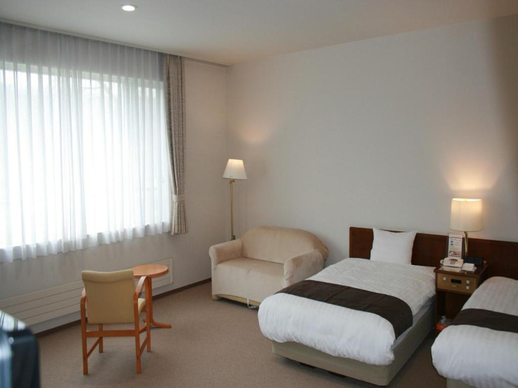 Кровать или кровати в номере Japanese Auberge Plaza Ryokufu Natural Hot Spring - Vacation STAY 03240v