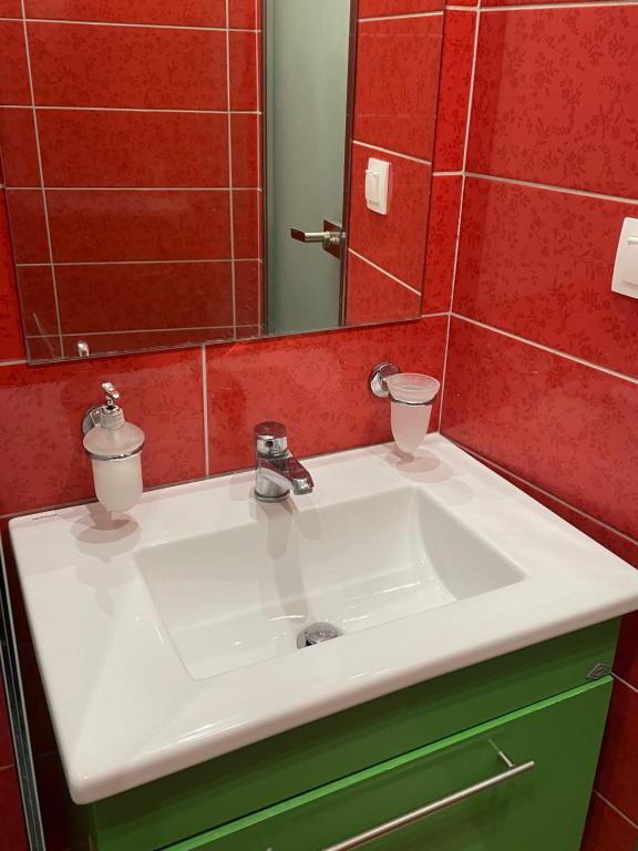 a bathroom with a white sink and a mirror at My home in Amalias