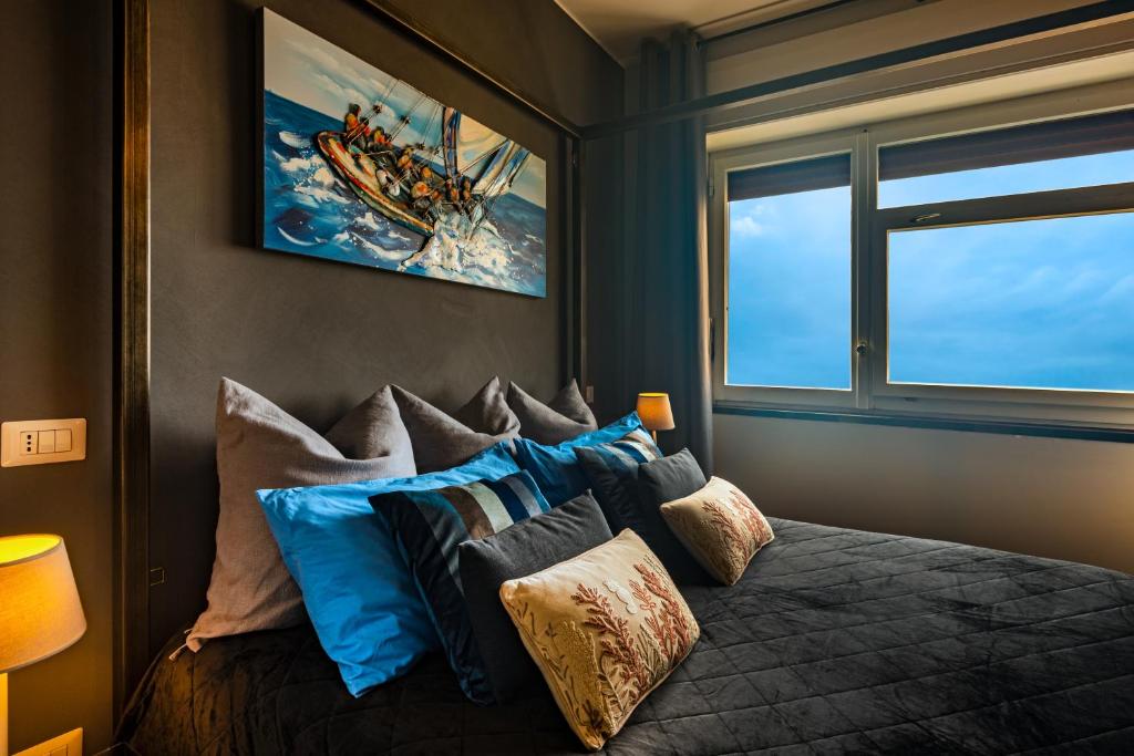 a bedroom with a bed with pillows and a window at B&B il Duca d'Amalfi in Salerno