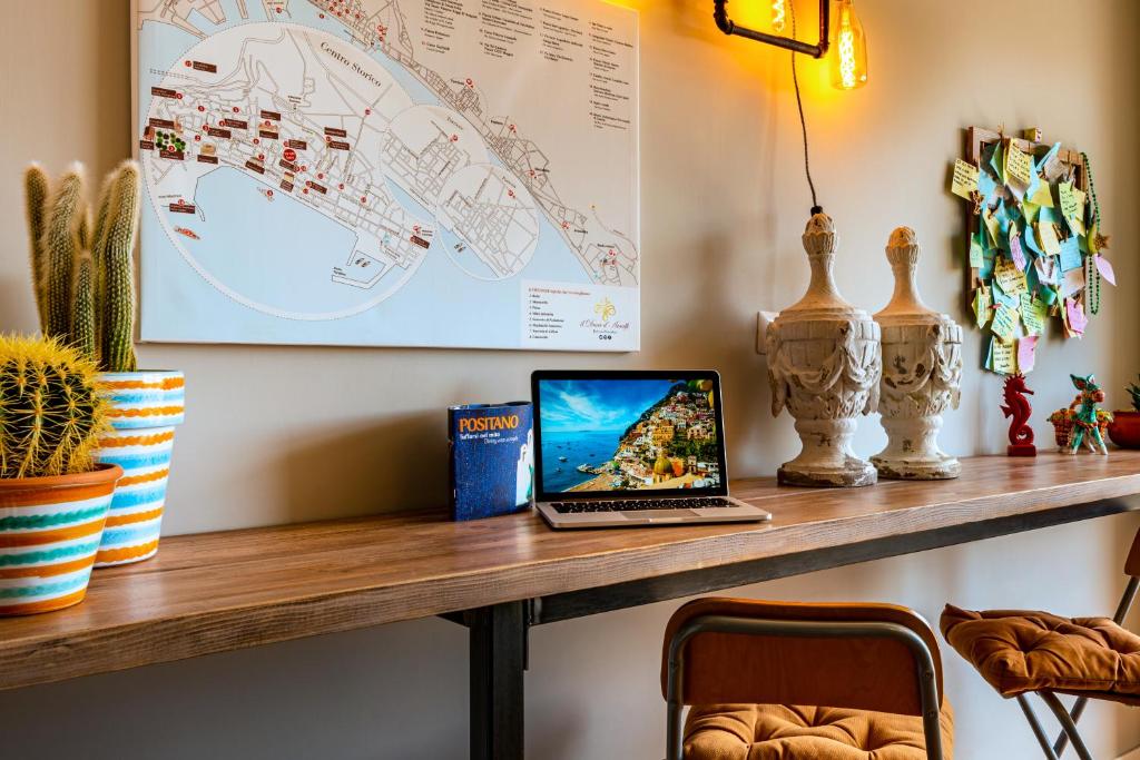 a laptop computer sitting on a wooden table at B&B il Duca d'Amalfi in Salerno