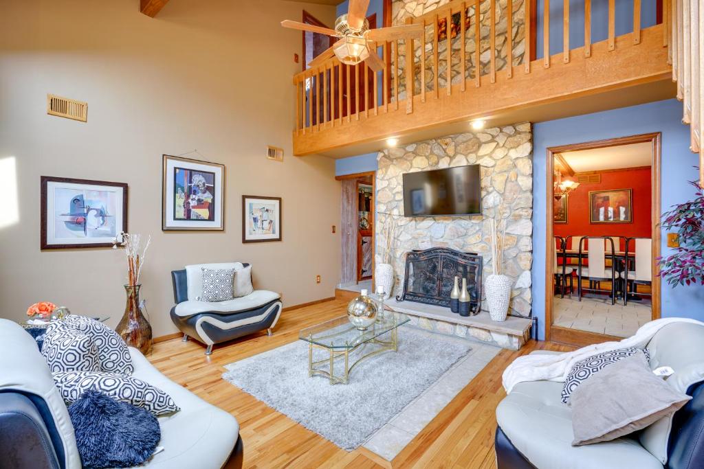a living room with a fireplace and a wooden floor at Lovely Ocean Gate Home Less Than 1 Mi to Beach! in Ocean Gate