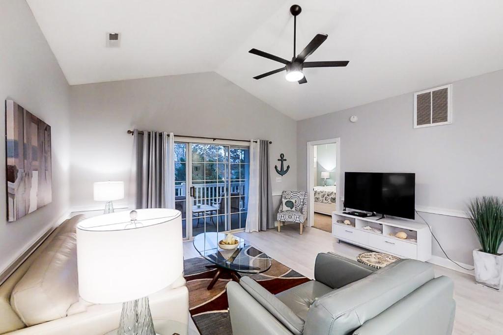 a living room with a couch and a flat screen tv at Riverwalk 301 in Myrtle Beach