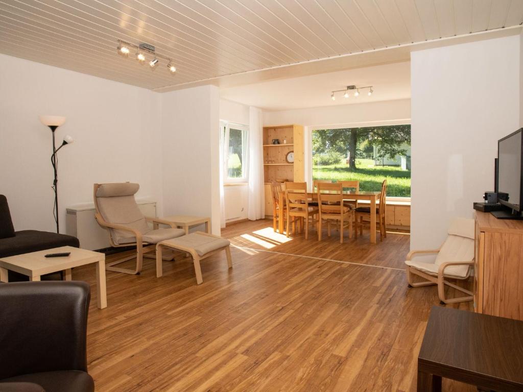 a living room and dining room with a table and chairs at Holiday home Reichenbach in Bayerstetten