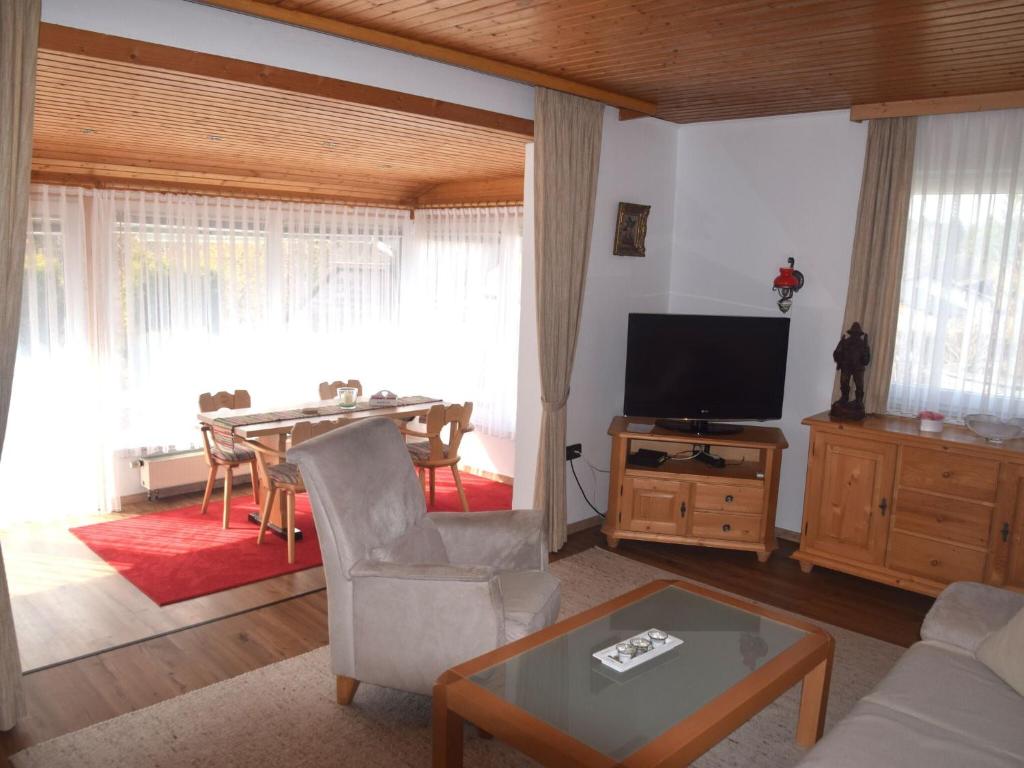 a living room with a table and a television at Vacation home Fussen in Füssen