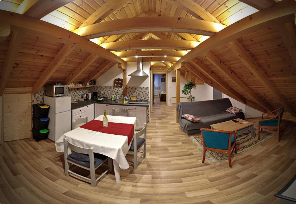 a kitchen and living room with a table and a couch at Apartman Tonka in Otočac