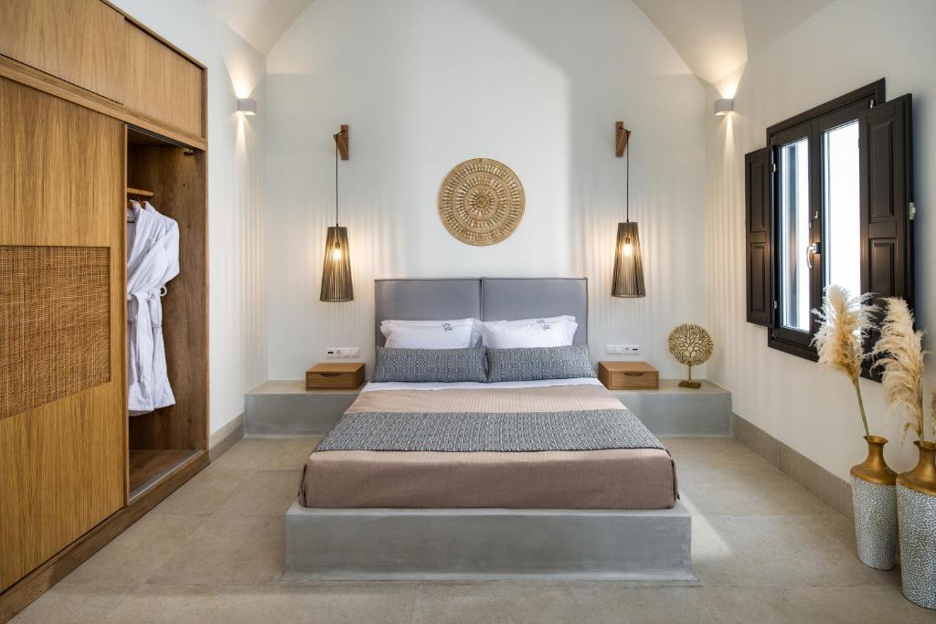 a bedroom with a king sized bed and a closet at Venus Sunrise Suites & Villas in Vourvoulos