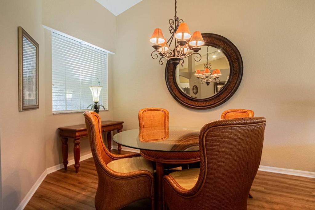 una sala da pranzo con un tavolo e uno specchio di Flamingo Fairways II a Lely Resort