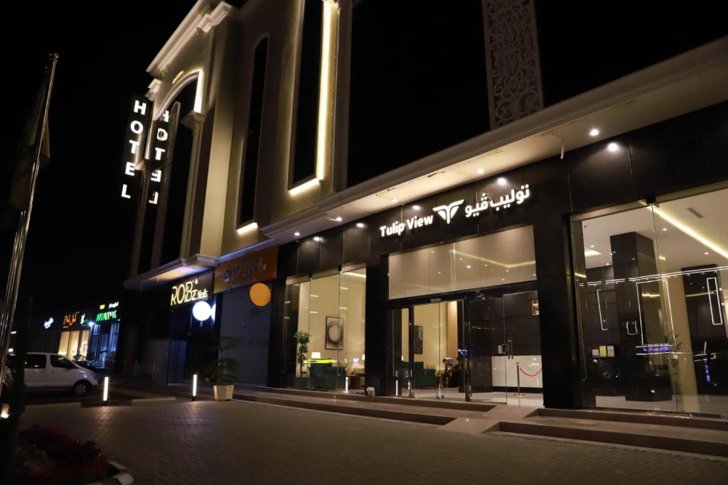 a store front of a building at night at Tulip View Hotel in Khamis Mushayt