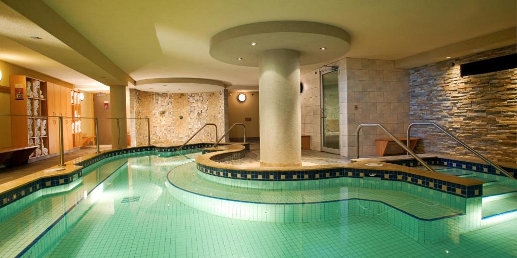 a large swimming pool in a hotel room at Banff Caribou Lodge and Spa in Banff