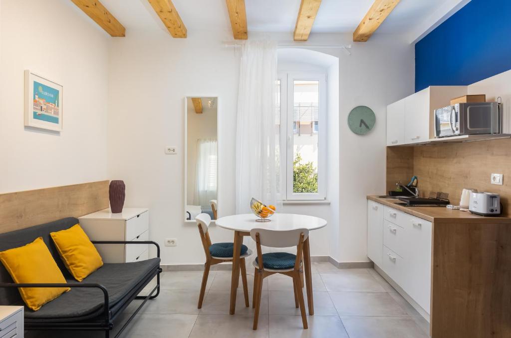 a kitchen and living room with a table and chairs at Blue sea Volantina in Dubrovnik