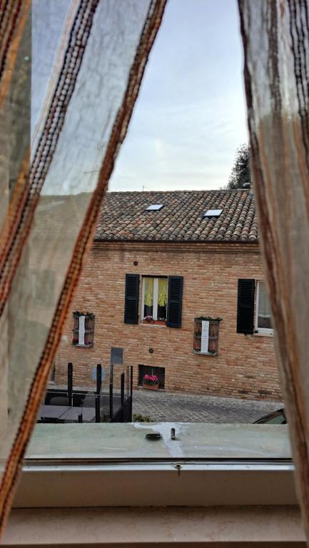 a view of a brick building from a window at La Casetta di Zia Palmina in Recanati