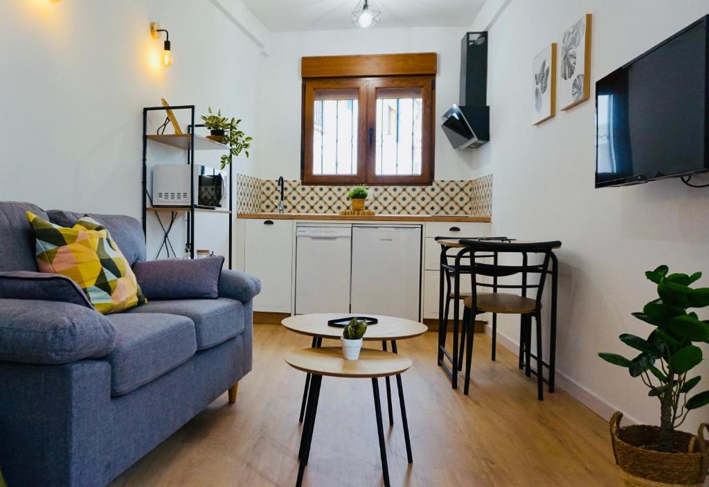 a living room with a couch and a table at La Alkarra in Alcalá del Júcar