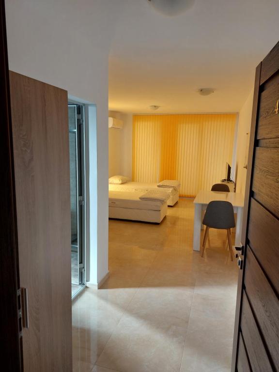 a room with a bed and a table and a bedroom at SAPPHIRE in Sozopol