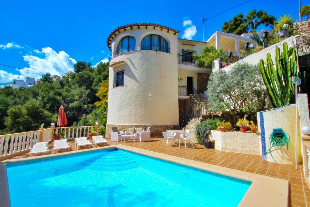 a villa with a swimming pool and a house at Monica II - holiday home with private swimming pool in Benissa in Benissa