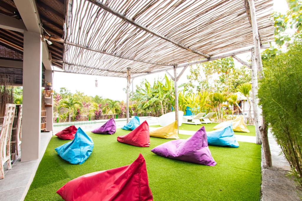 a group of colored pillows on the floor of a house at Nusa Penida Yurt in Nusa Penida