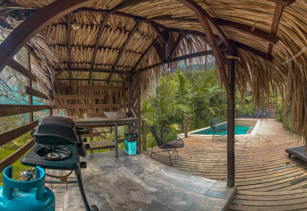 an outside view of a bamboo house with a swimming pool at All Natural Glamping in Copacabana