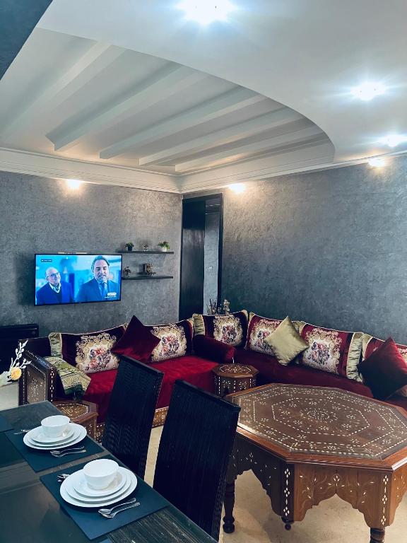 a living room with a couch and a table at Deluxe apartments in Casablanca