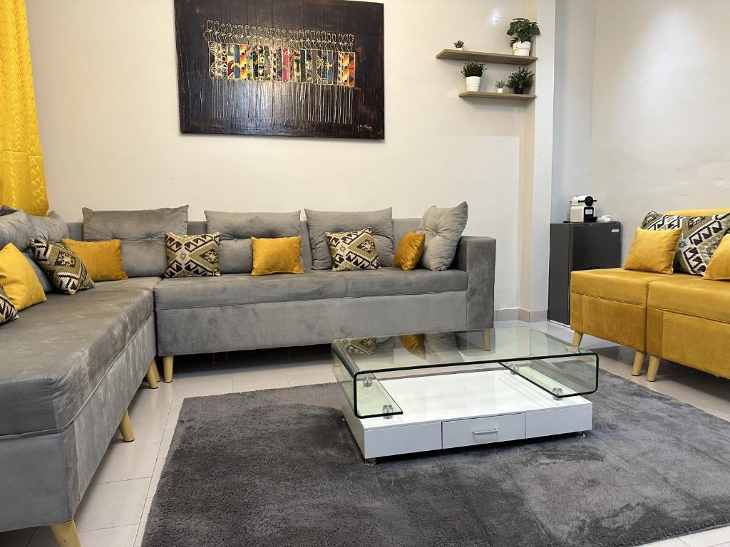 a living room with a couch and a coffee table at F2 Appart Les Ambassades Point E, Dakar in Dakar