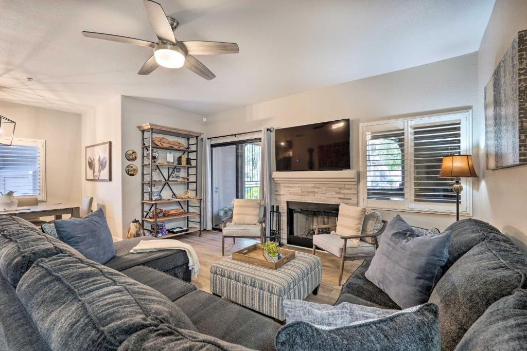 a living room with a couch and a ceiling fan at Scottsdale Condo Pool, Hot Tub and Grill Access! in Scottsdale