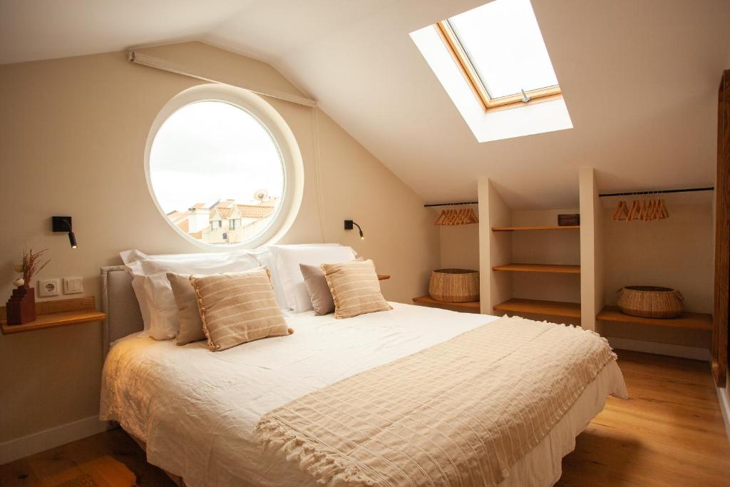 a bedroom with a bed with a large window at Vila Rodrigues in Lisbon